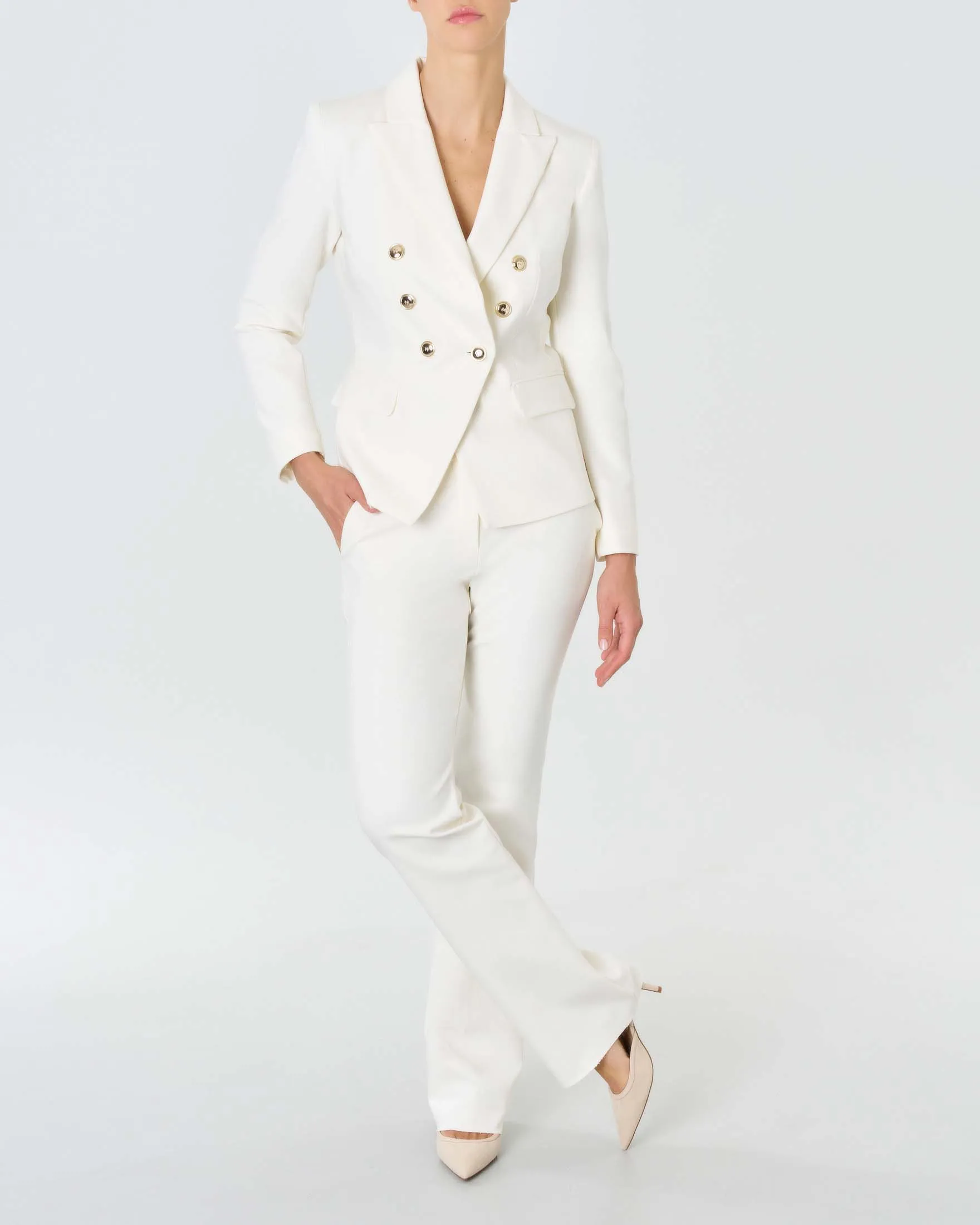 Pantaloni color panna in misto cotone stretch dalla linea flare al fondo